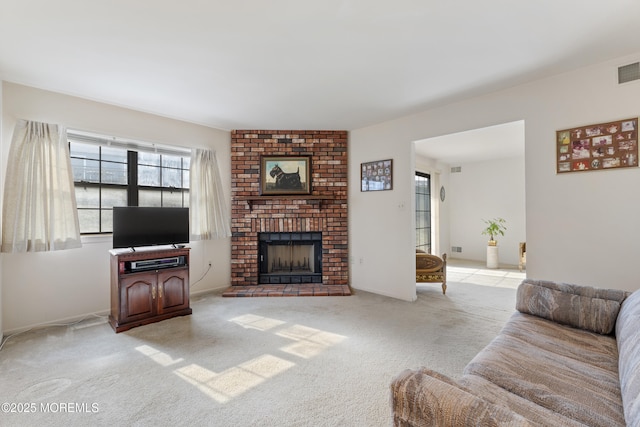 living room with light carpet, a brick fireplace, and visible vents