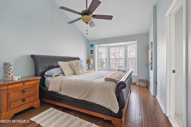 bedroom featuring high vaulted ceiling, a ceiling fan, baseboards, and dark wood-type flooring