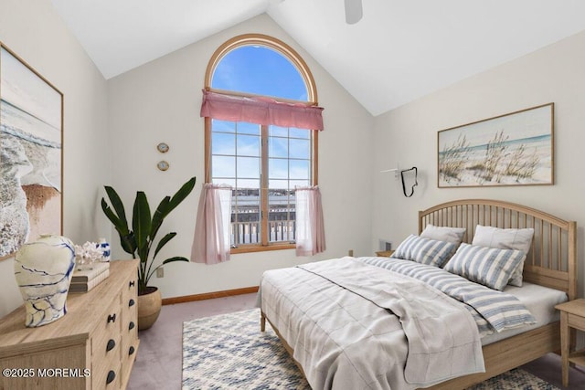 bedroom with ceiling fan, carpet, baseboards, and vaulted ceiling