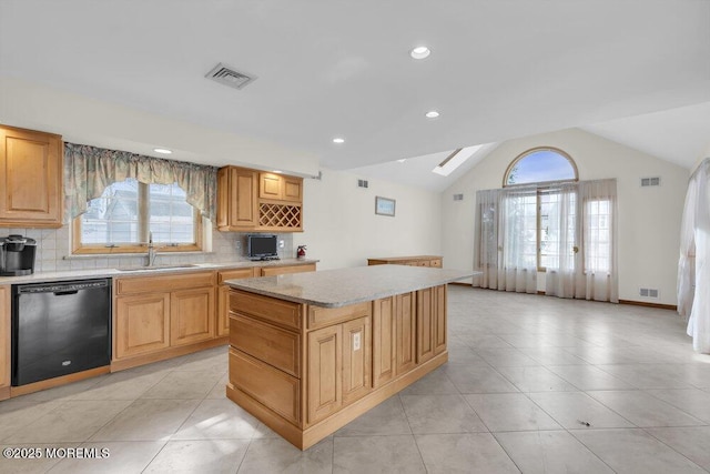 kitchen with black dishwasher, a sink, and visible vents