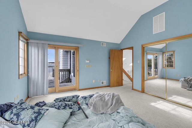 bedroom featuring access to outside, multiple windows, and visible vents