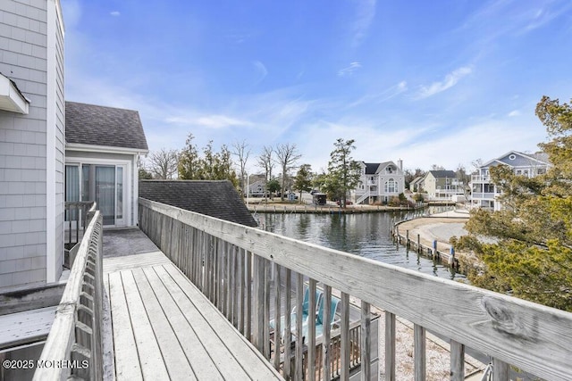 wooden deck with a water view and a residential view