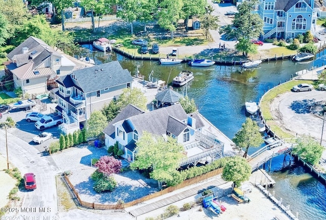 drone / aerial view featuring a residential view and a water view