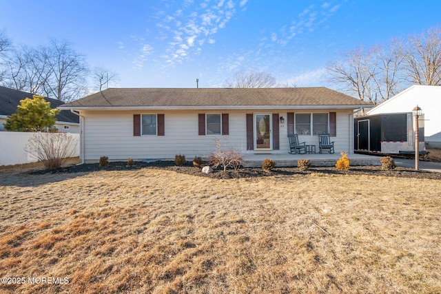 back of house with fence and a yard