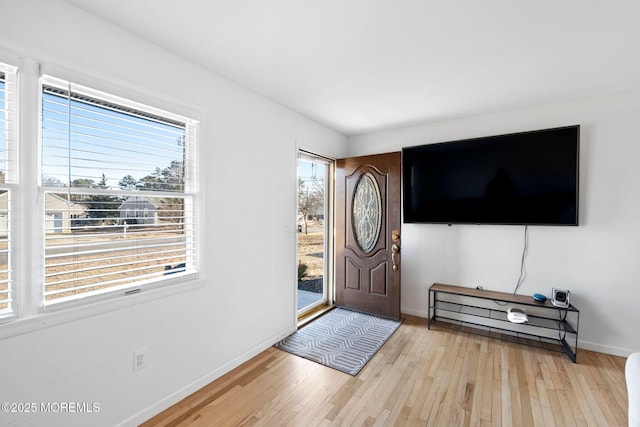 foyer featuring light wood-style flooring and baseboards