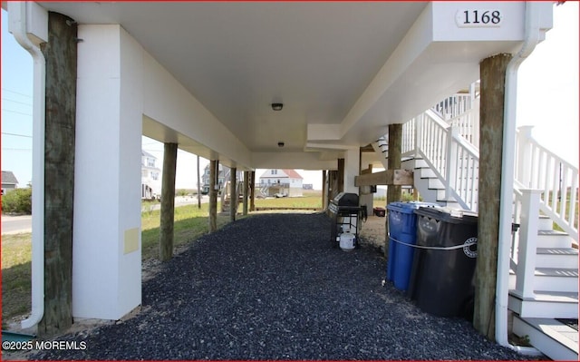 view of patio with a grill and stairway