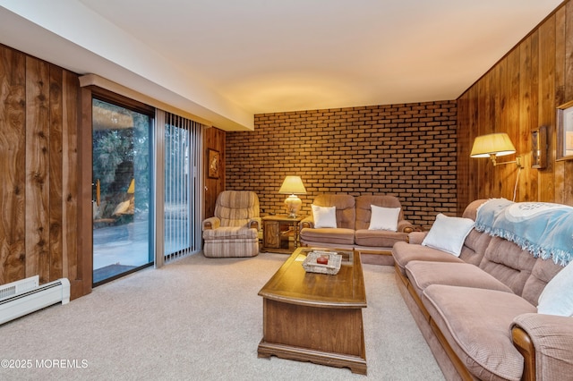 living area featuring brick wall, wood walls, a baseboard radiator, and light colored carpet