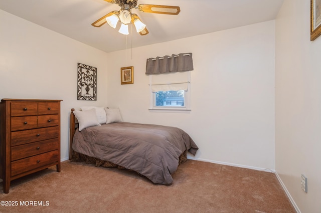 bedroom featuring light carpet, ceiling fan, and baseboards