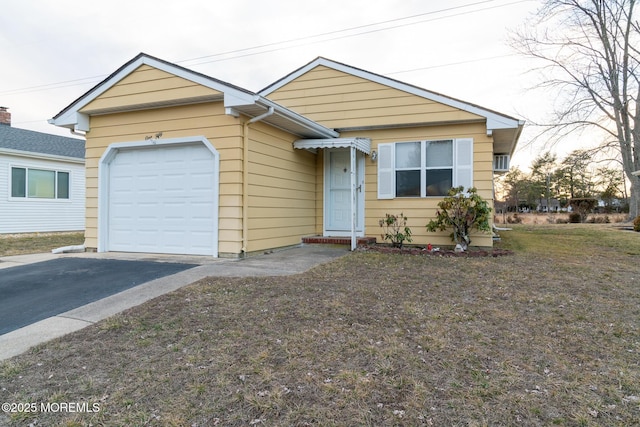 view of front of home featuring a garage and aphalt driveway