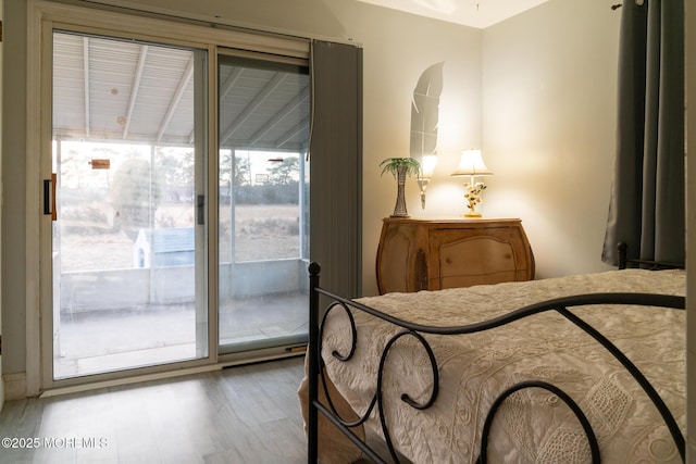 bedroom featuring access to outside and wood finished floors