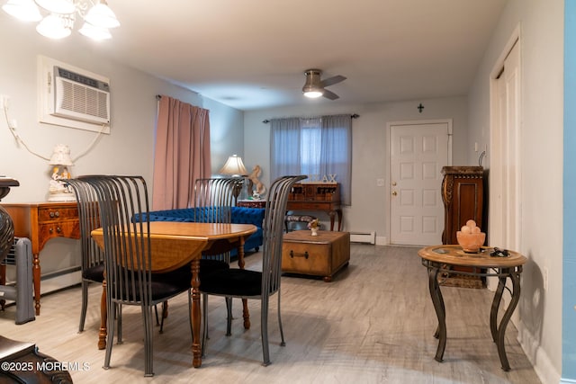 dining area with ceiling fan, baseboards, light wood-style floors, a wall mounted AC, and baseboard heating