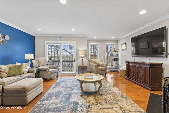 living area featuring ornamental molding, wood finished floors, and recessed lighting