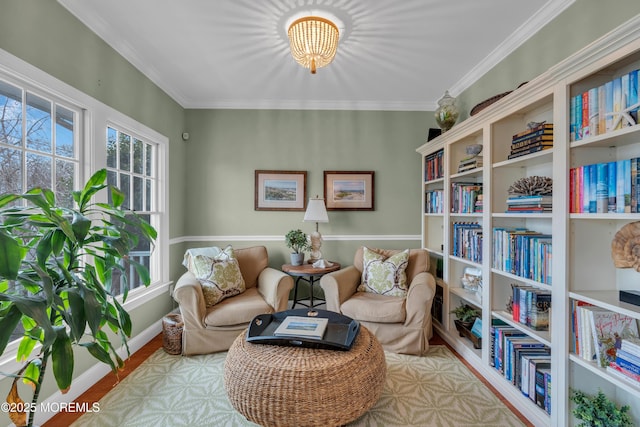 sitting room with baseboards and crown molding