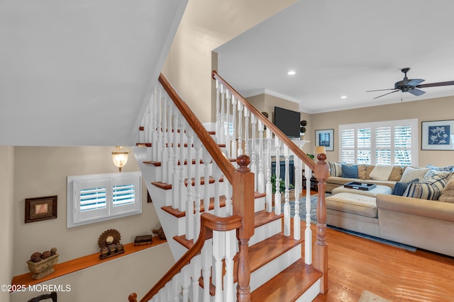 staircase with crown molding, wood finished floors, a ceiling fan, and recessed lighting