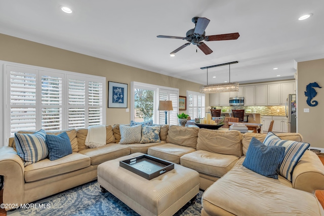 living area with a ceiling fan and recessed lighting