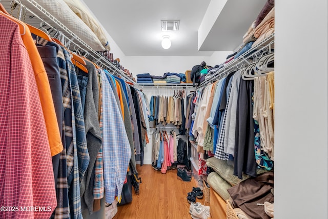 spacious closet featuring visible vents and wood finished floors