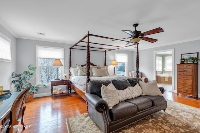 bedroom featuring ornamental molding, visible vents, light wood finished floors, and multiple windows