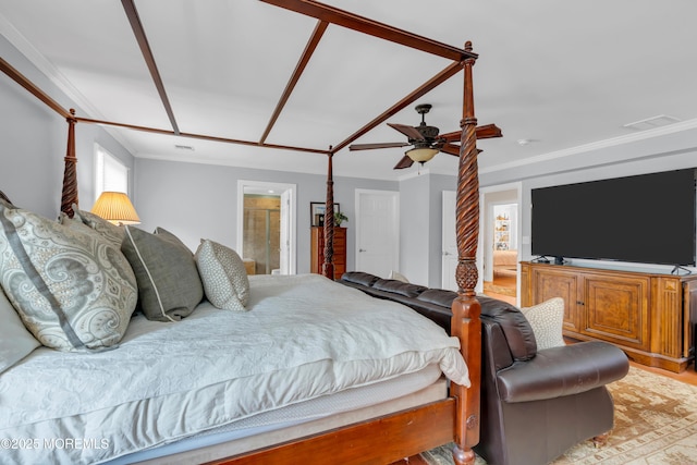 bedroom featuring visible vents, a ceiling fan, light wood-style flooring, ornamental molding, and ensuite bathroom