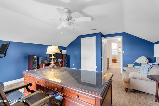 office space with light carpet, vaulted ceiling, visible vents, and baseboards