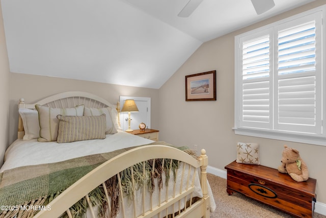 bedroom featuring carpet floors, vaulted ceiling, baseboards, and a ceiling fan