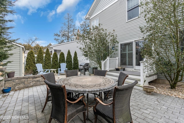 view of patio with outdoor dining space and a grill