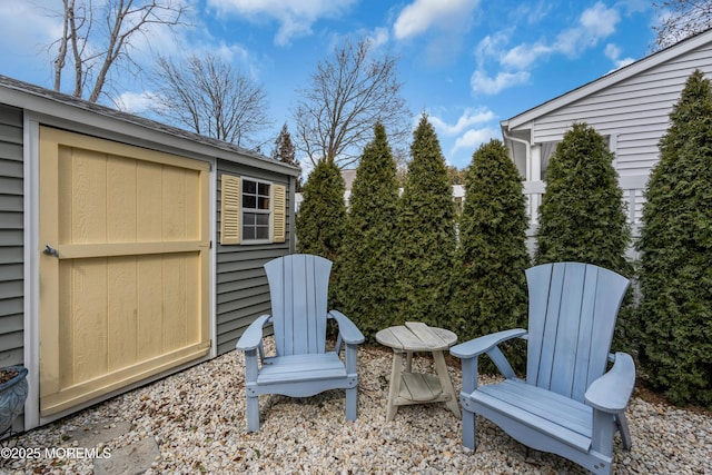 view of patio / terrace with an outbuilding and a storage shed