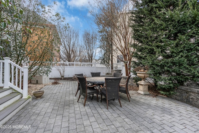 view of patio with fence and outdoor dining space