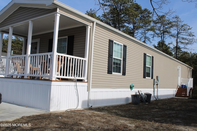 view of side of home with a porch