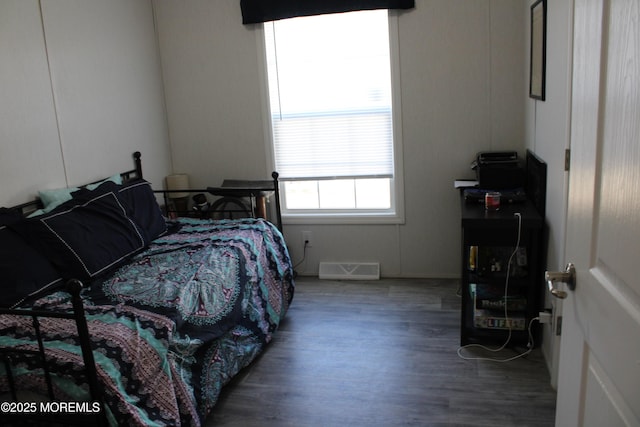 bedroom featuring dark wood-style floors and visible vents