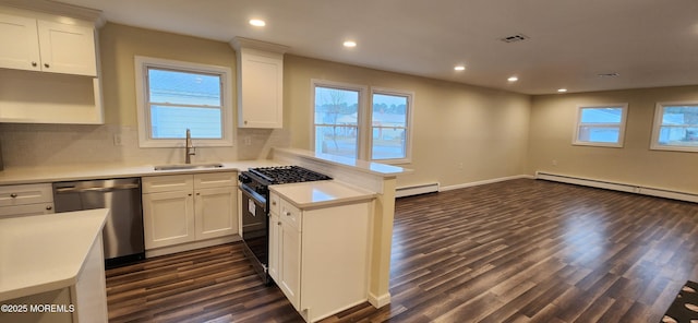 kitchen with dishwasher, black range with gas stovetop, a sink, and white cabinets