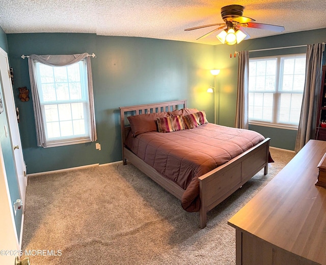 bedroom with light carpet, a textured ceiling, and multiple windows