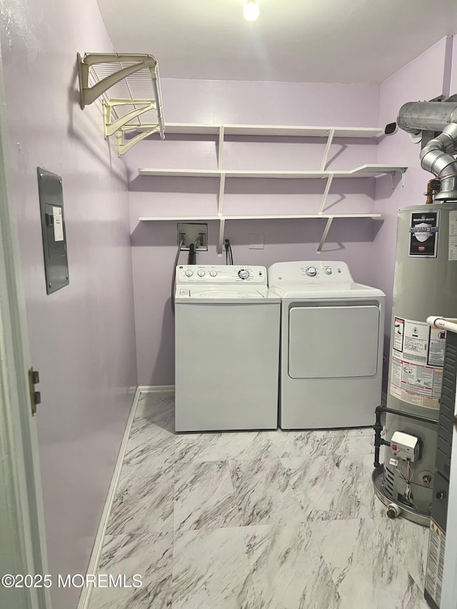 clothes washing area featuring marble finish floor, washer and clothes dryer, gas water heater, and laundry area