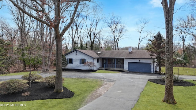 single story home featuring a garage, a front lawn, curved driveway, and a chimney