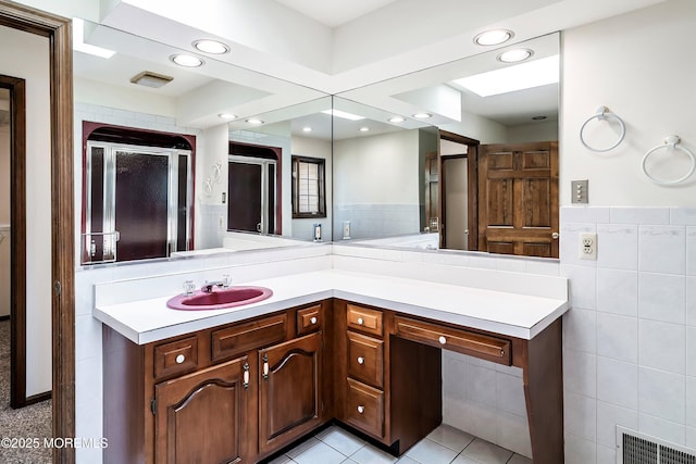 bathroom with recessed lighting, visible vents, vanity, tile walls, and tile patterned floors