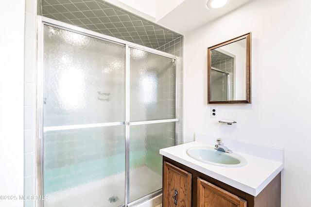 full bathroom featuring a stall shower and vanity