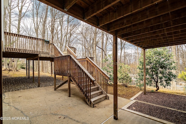 view of patio with a wooden deck and stairs