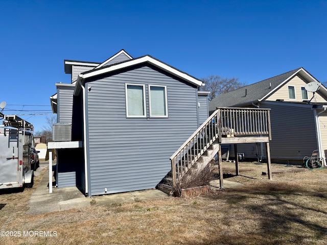 back of property featuring a deck and stairway