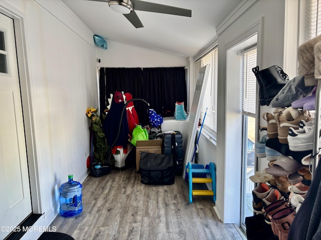 interior space featuring lofted ceiling, light wood-style flooring, baseboards, and a ceiling fan