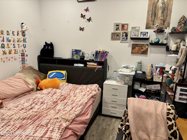 bedroom featuring wood finished floors