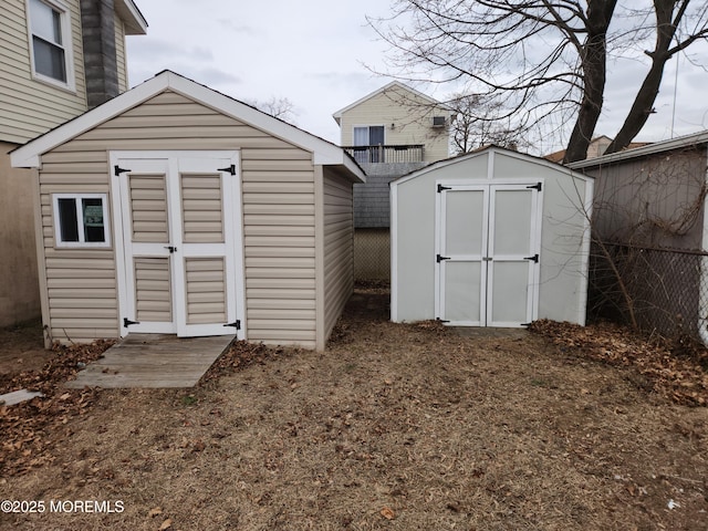 view of shed featuring fence