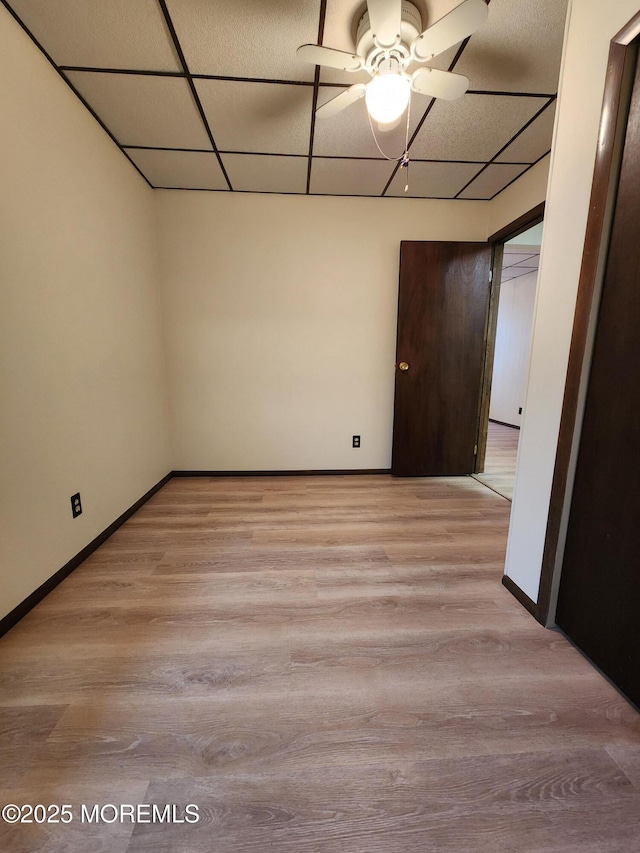 spare room with light wood-type flooring and baseboards