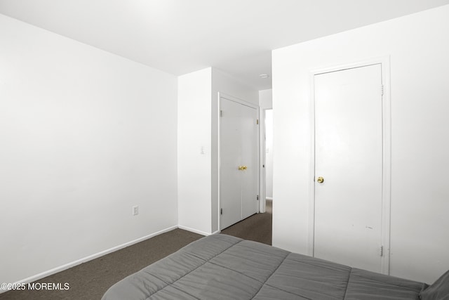 bedroom with baseboards and carpet