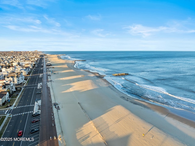 aerial view featuring a view of the beach and a water view