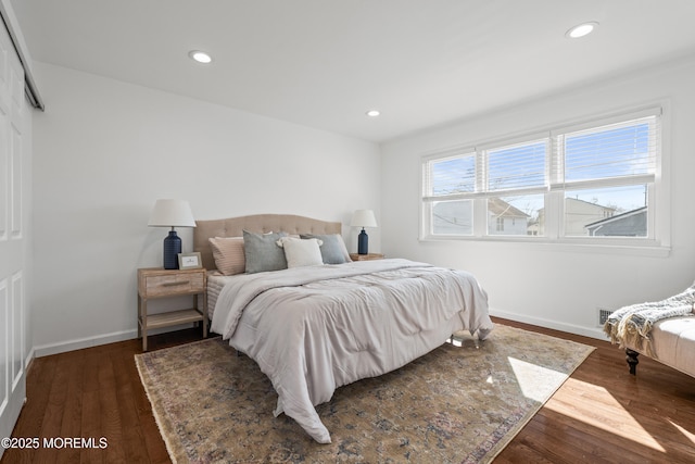 bedroom featuring dark wood-type flooring, recessed lighting, and baseboards