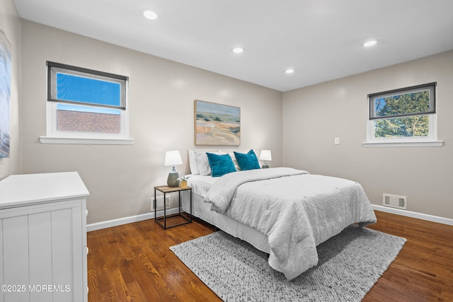 bedroom with recessed lighting, visible vents, baseboards, and dark wood finished floors