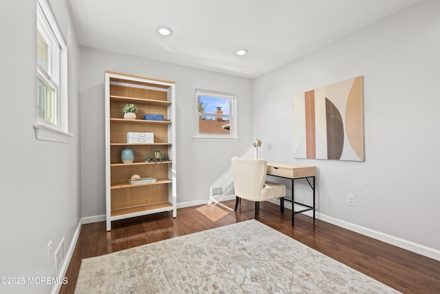 home office featuring visible vents, baseboards, and wood finished floors