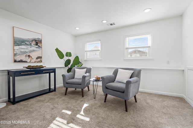 living area with recessed lighting, visible vents, baseboards, and carpet