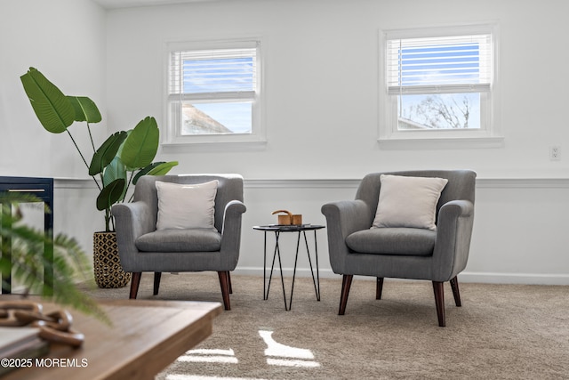 sitting room with baseboards and carpet floors