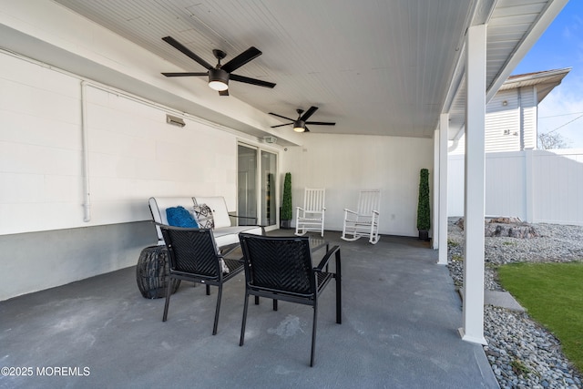 view of patio / terrace featuring ceiling fan and fence