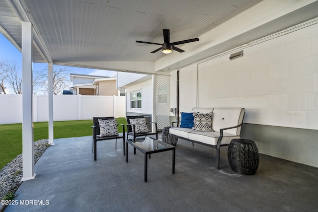 view of patio with outdoor lounge area, ceiling fan, and fence